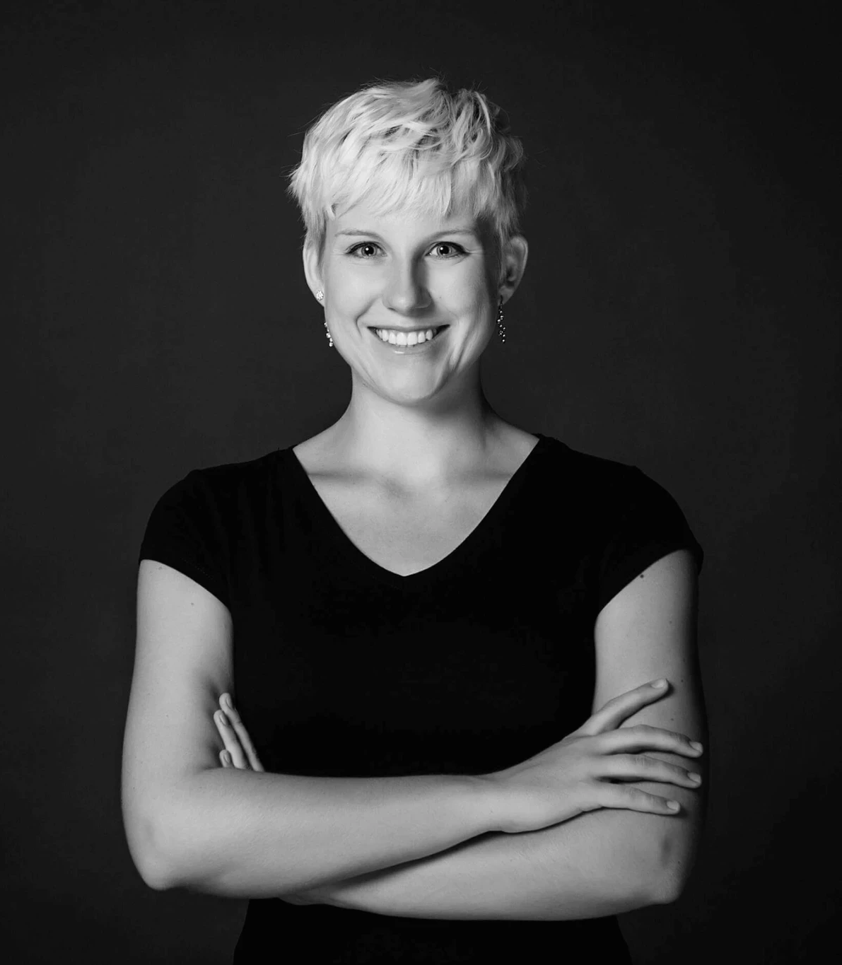 Person Kristin Baumann. Black and white. Frontal facing. Smiling